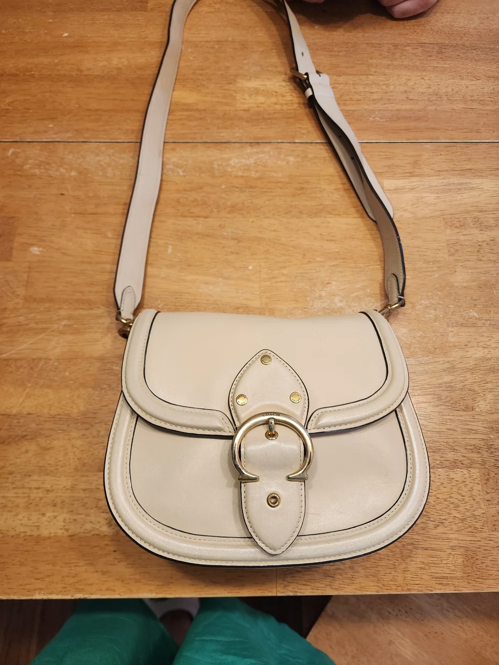 2021 Ivory Coach Beat saddle bag is crafted from glovetanned leather and brass